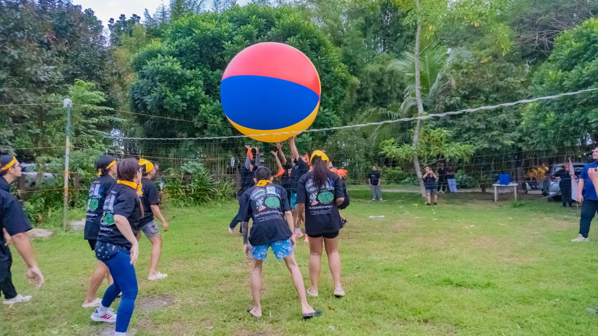 Team playing giant ball volleyball